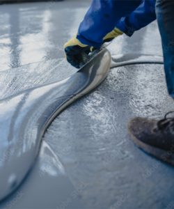 Professional installer spreads epoxy onto floor